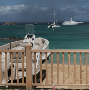 Iguana boat with tracks in front of a hotel